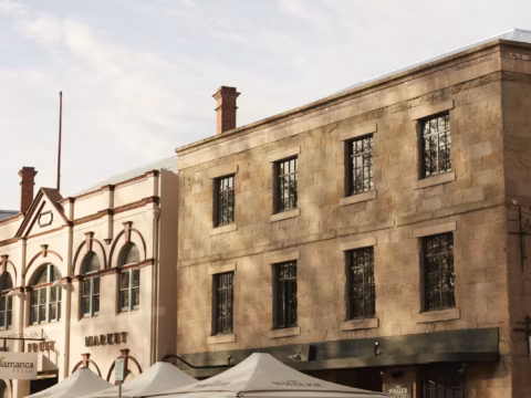 Sunlit upper stories and multi-pane windows of the historic building at Salamanca Place